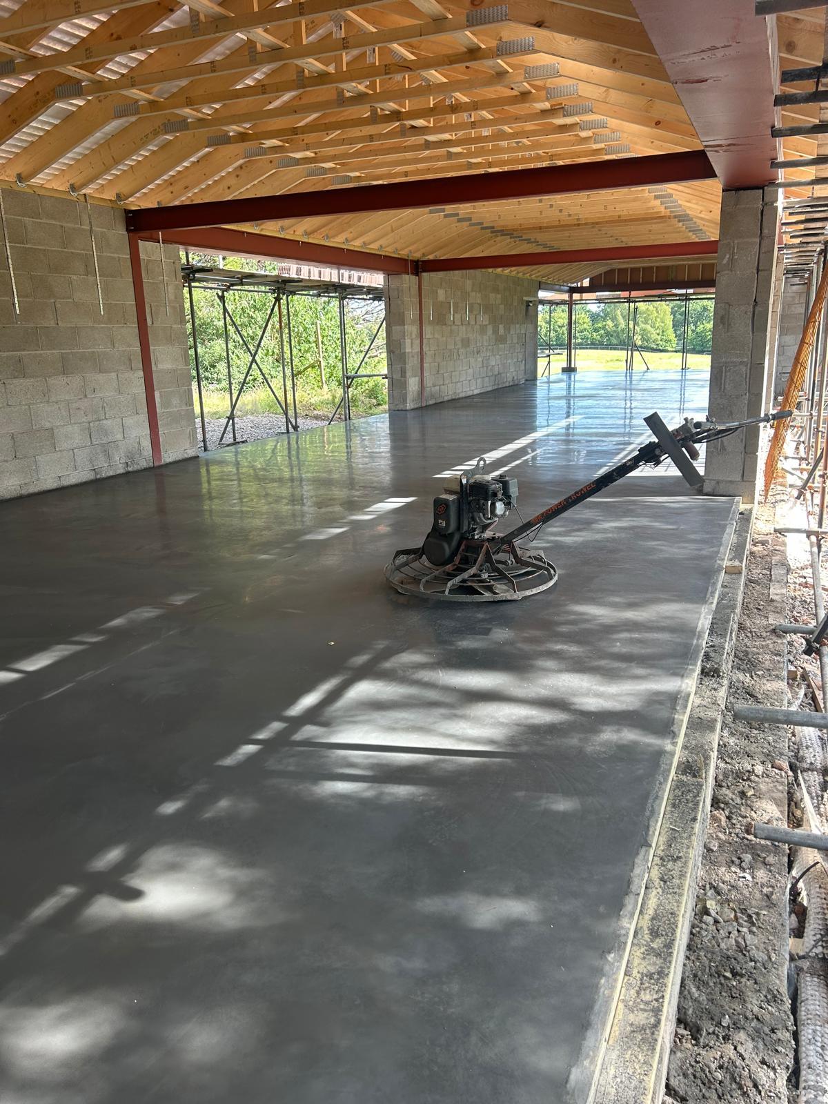 Liquid screed being pumped over underfloor heating